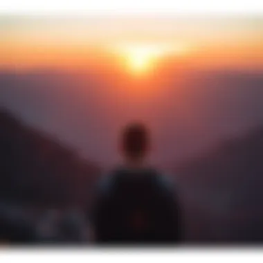 A person looking out at a sunset from a mountain top, symbolizing hope and new beginnings in overcoming gambling addiction.