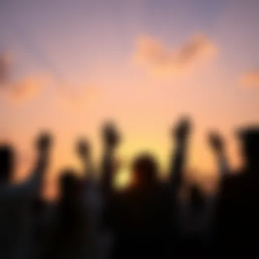 A group of people standing together, raising their hands in a gesture of hope and unity during a sunset.