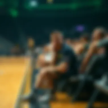 Jokic on the Bench Nikola Jokic sitting on the bench during a game, looking concerned while teammates are on the court