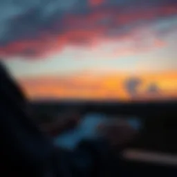 A person looking at a sunset while writing in a planner, symbolizing future planning.