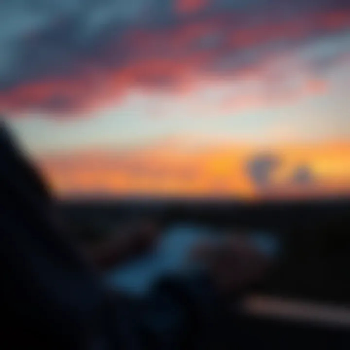 A person looking at a sunset while writing in a planner, symbolizing future planning.